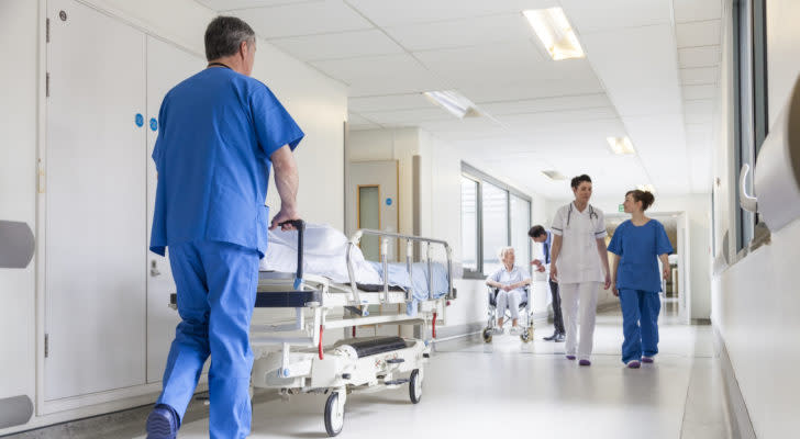 Image of a hospital with workers walking in the halls