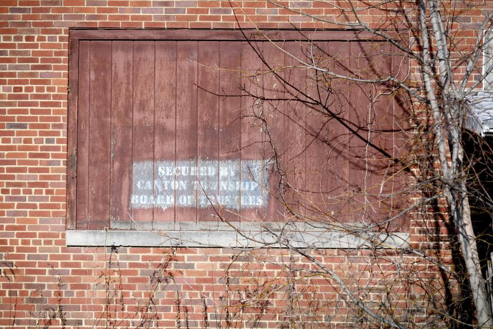 Because the former North Industry School attracts intruders, township officials have fastened chain-link fence guards over the windows, which have been covered with wooden sheets.