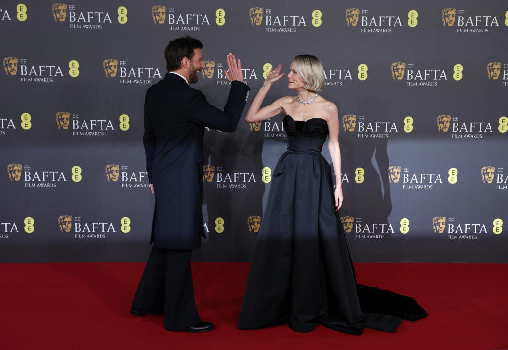 Bradley Cooper and Carey Mulligan high-five each other at the 2024 British Academy of Film and Television Awards (BAFTA) at the Royal Festival Hall in the Southbank Centre, London, Britain, February 18, 2024. REUTERS/Isabel Infantes