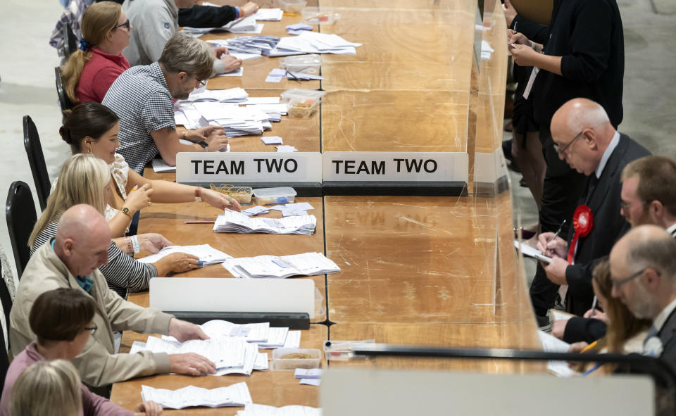 Votes are counted at Selby Leisure Centre in Selby, North Yorkshire, England, Thursday, July 20, 2023, in the Selby and Ainsty by-election, called following the resignation of incumbent MP Nigel Adams. Voters went to the polls Thursday in three electoral districts of England, with the governing Conservative Party braced for a drubbing over a cost-of-living crisis and a morale-sapping string of political scandals. (Danny Lawson/PA via AP)