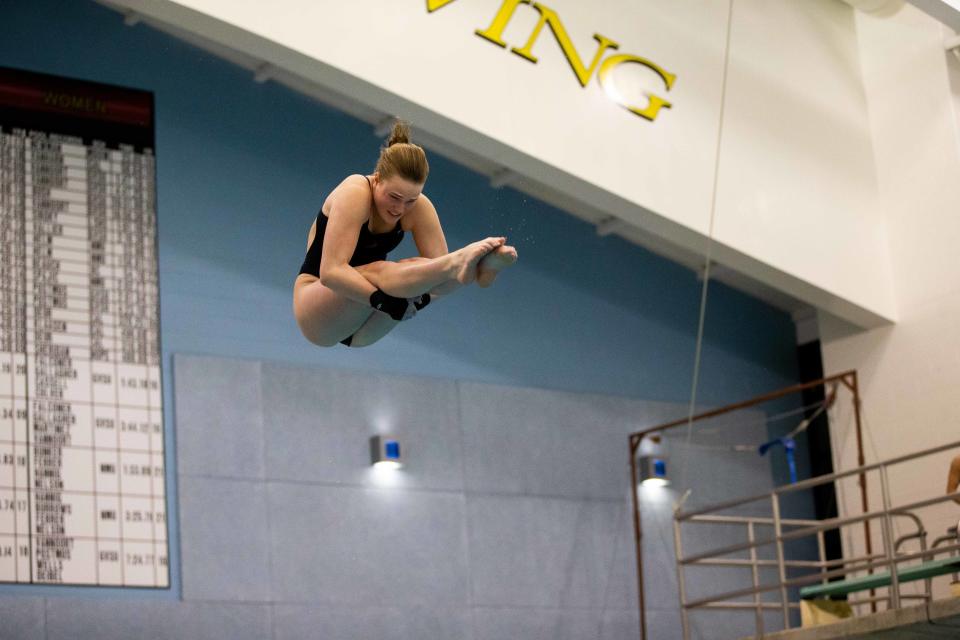 Hope's Abby Koops dives off the 1 meter platform during the MIAA Finals Thursday, Feb. 16, 2023, at Calvin University. 