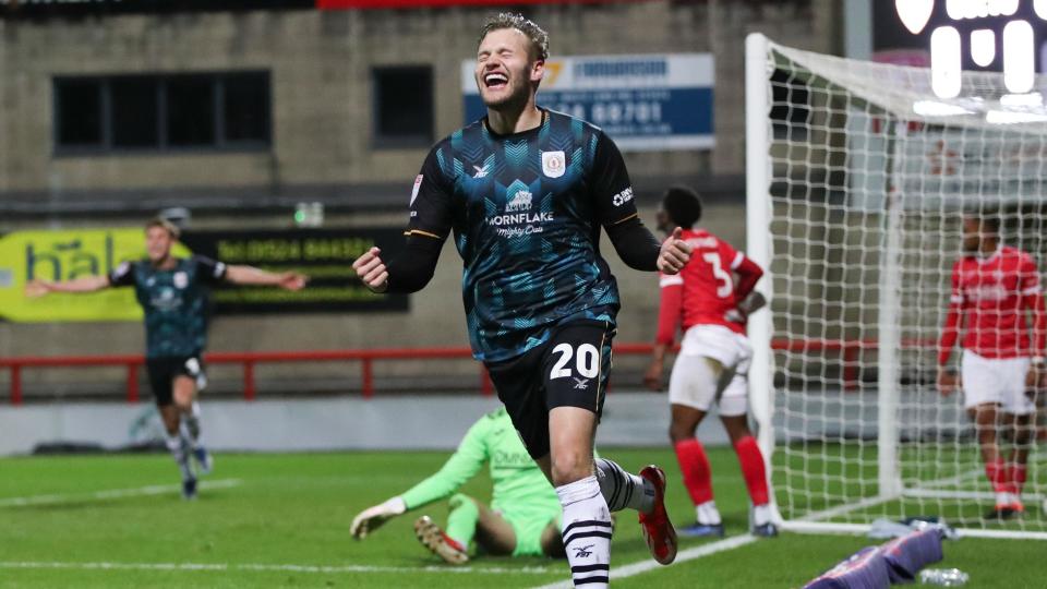 Elliott Nevitt celebrates scoring a goal for Crewe