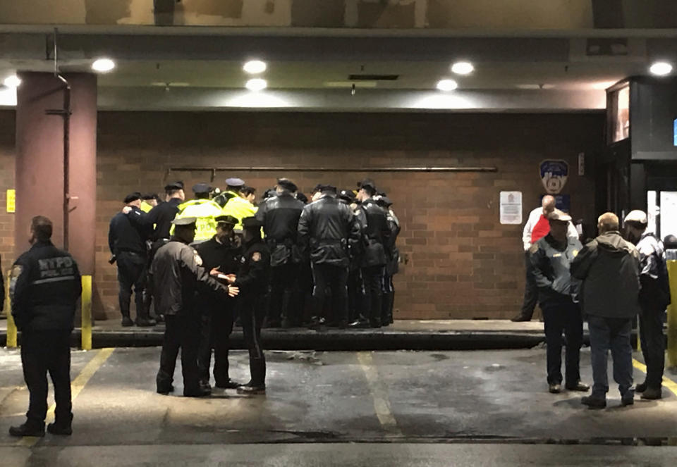 New York City police officers gather at Jamaica Hospital in the Queens borough of New York after a few NYPD officers while responding to a robbery in a mobile phone store on Tuesday, Feb. 12, 2019. One of them was killed Tuesday night while responding to a report of a gunpoint robbery at a cellphone store, an official briefed on the matter told The Associated Press. The official was not authorized to speak publicly and spoke on condition of anonymity. (AP Photo/Stephen Groves)