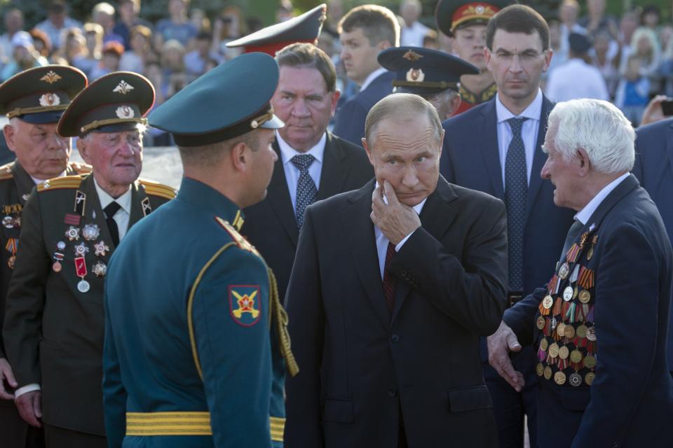 Russian President Vladimir Putin, second right, speaks to WWII veterans as he arrives to attend a laying ceremony in Kursk, 426 kilometers (266 miles) south of Moscow, Russia, Thursday, Aug. 23, 2018. Putin attends a ceremony marking the 75th anniversary of the battle of Kursk in which the Soviet army routed Nazi troops. It is described by historians as the largest tank battle in history involving thousands of tanks. (AP Photo/Alexander Zemlianichenko, Pool)