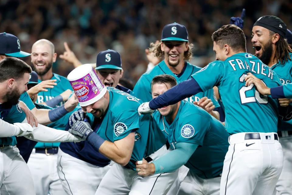 SEATTLE, WASHINGTON - SEPTEMBER 30: Cal Raleigh #29 of the Seattle Mariners celebrates his walk-off home run during the ninth inning against the Oakland Athletics at T-Mobile Park on September 30, 2022 in Seattle, Washington. With the win, the Seattle Mariners have clinched a postseason appearance for the first time  in 21 years, the longest playoff drought in North American professional sports. (Photo by Steph Chambers/Getty Images)