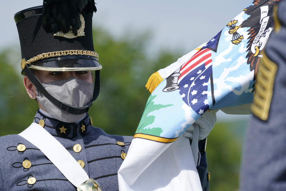 Virginia Military Institute new Corps of Cadet Commander Kasey Meredith, of Johnstown, Pa., receives the regimental flag during a change of command parade and ceremony on the parade grounds at the school in Lexington, Va., Friday, May 14, 2021. Meredith will be the first female to lead the Virginia Military Institute's Corps of Cadets in its 182 year history. (AP Photo/Steve Helber)