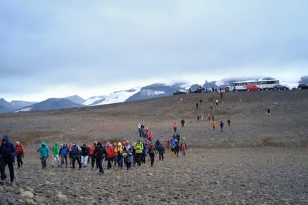 People walk towards Okjokull glacier in Iceland