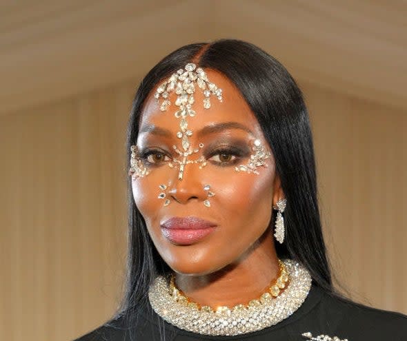 Naomi Campbell wearing face jewelry and matching earrings and necklace