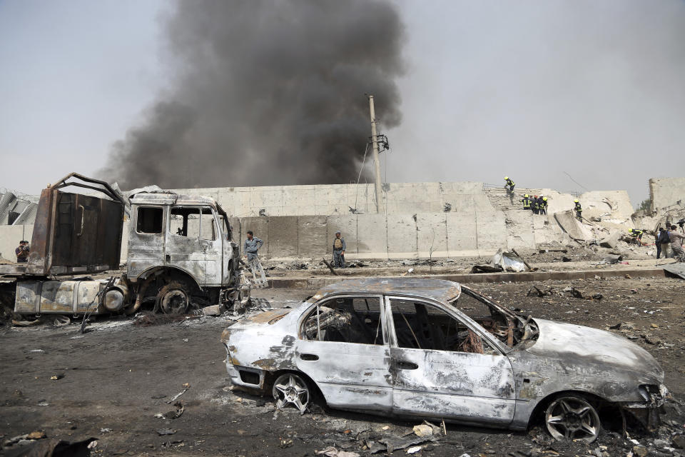 Afghan firefighters work at the site of Monday's suicide bomb attack in Kabul, Afghanistan, Tuesday, Sept. 3, 2019. The attack occurred late Monday near the the Green Village, home to several international organizations and guesthouses. (AP Photo/Rahmat Gul)