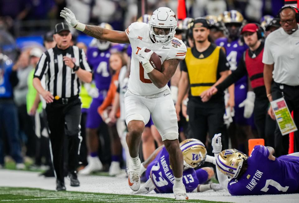 Texas tight end Ja'Tavion Sanders evades the Washington defense during the College Football Playoff semifinals won by Washington on Jan. 1 in New Orleans. Sanders is among the 11 Texas football players invited to the upcoming NFL combine.