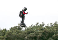 French inventor Franky Zapata flies near St. Margaret's beach, Dover after crossing the Channel on a flying board Sunday, Aug. 4, 2019. (Steve Parsons/PA via AP)