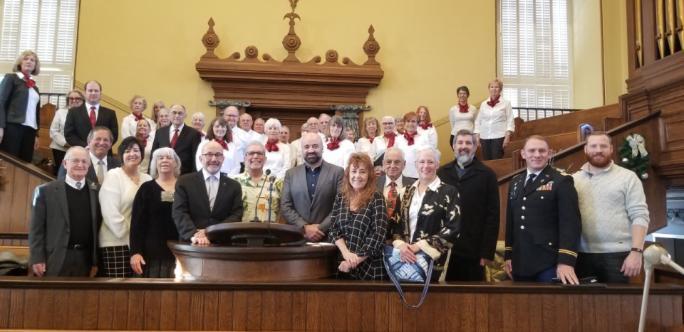 The 2022 Prayer Over the City group photo included, from left to right in the front row, President Gardner of S St George Historic Sites, Washington County Commissioner Gil Almquist, St. George Mayor Michele Randall, Rabbi Helene Ainbinder, Reverend Dr. Ralph Clingan, Reverend Jimi Kestin, Shadman Bashir, Reverend Rickine Kestin, Reverend Alex Wilkie, Baha'i Laura Fairchild, Father Dave Bittmenn, Major David Jones, Uriah Hernalsteen. The St George Interfaith Choir is pictured in background.