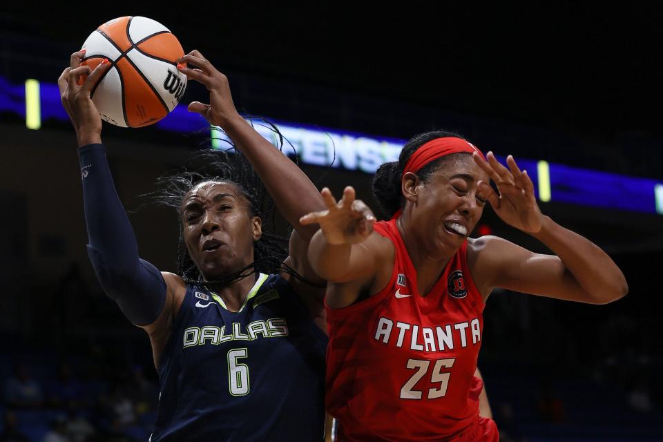 The Dallas Wings' Kayla Thornton rebounds the ball against Atlanta Dream forward Monique Billings.