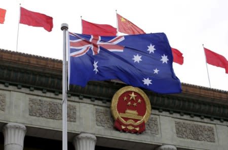 FILE PHOTO: Australian flag flutters in front of the Great Hall of the People during a welcoming ceremony for Australian Prime Minister Malcolm Turnbull (not in picture) in Beijing, China, April 14, 2016. REUTERS/Jason Lee/File Photo
