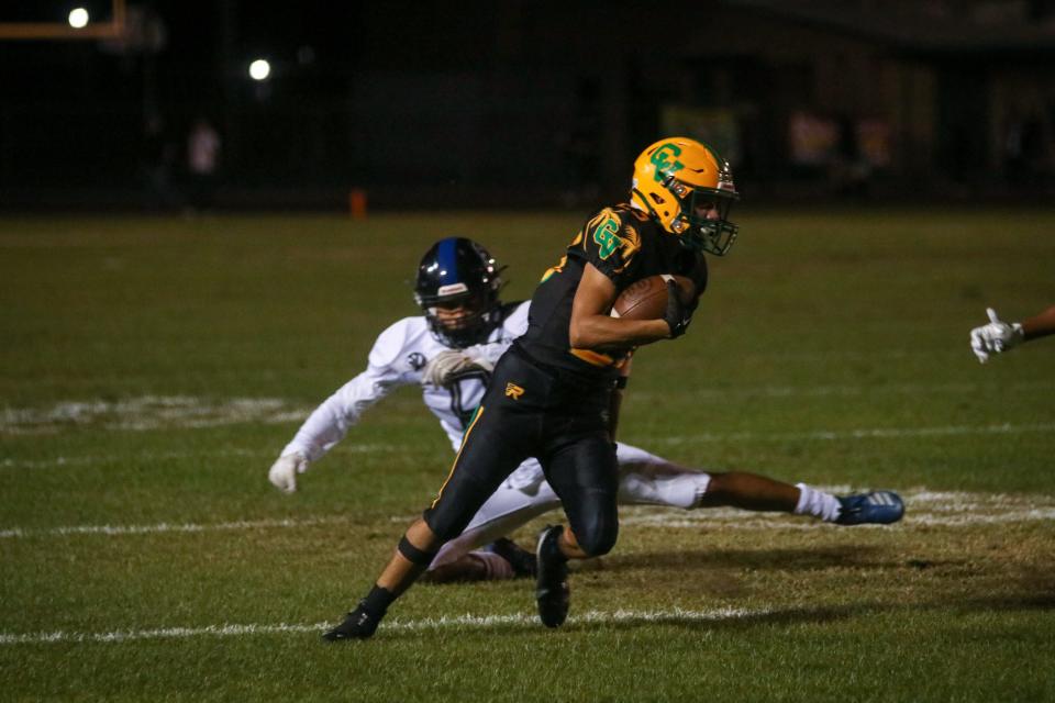 Coachella Valley's Aaron Ramirez (23) avoiding Cathedral City's defense to get further yards for another first down, Oct. 14, 2022.