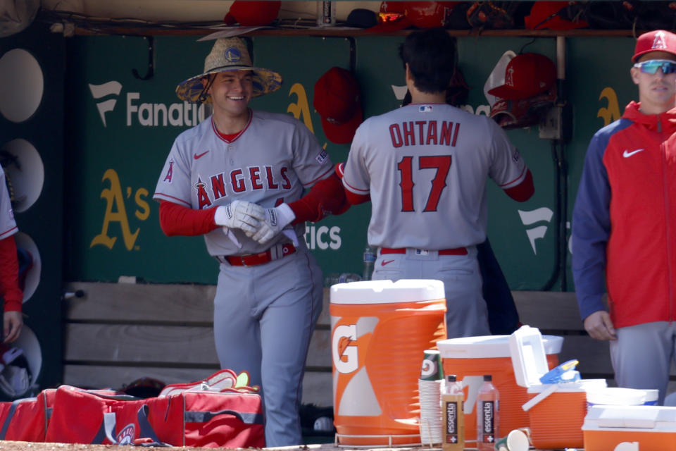 Los Angeles Angels' Logan O'Hoppe, left, is congratulated by teammate Shohei Ohtani (17) after hitting a thee-run home run during the fourth inning of a baseball game against the Oakland Athletics in Oakland, Calif., Sunday, April 2, 2023. (AP Photo/Jed Jacobsohn)