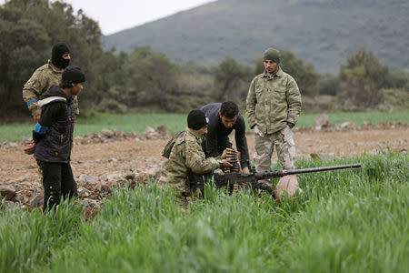 Turkish-backed Free Syrian Army fighters are seen near the city of Afrin, Syria February 21, 2018. REUTERS/Khalil Ashawi