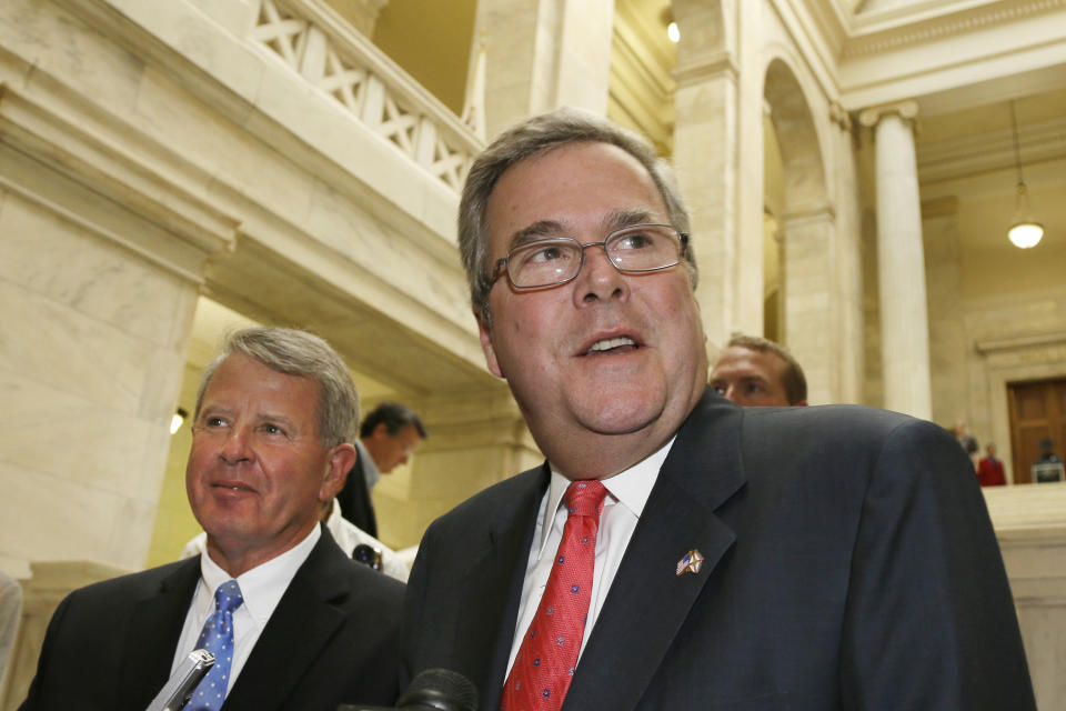 FILE - This Jan. 29, 2013 file photo shows former Florida Gov. Jeb Bush, right, speaks to reporters after an education rally at the Arkansas state Capitol in Little Rock, Ark., as he stands with Luke Gordy of Arkansans for Better Schools. Will Jeb Bush run for president? The former Florida governor says he’s undecided but his decision is one of the most significant unknowns looming over the 2016 Republican presidential contest. A White House bid by the scion of the Bush political dynasty would shake up a wide-open field and set up a showdown with the tea party movement. (AP Photo/Danny Johnston, File)