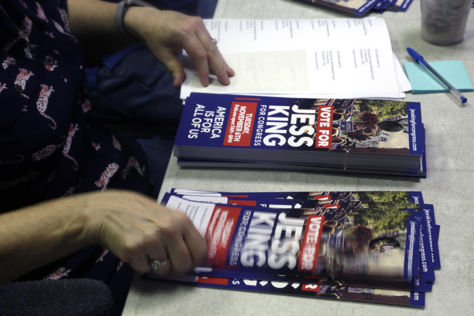 A volunteer puts address stickers with voting location on a door hanger promoting Jess King, a Democratic candidate in Pennsylvania's 11th Congressional District, Friday Nov. 2, 2018, in Lancaster, Pa. Voters in Pennsylvania's rolling dairy farms and Amish countryside had rarely, if ever, seen a Democrat mount a competitive campaign for Congress, until now. From all appearances, first-time candidate Jess King is giving freshman Republican U.S. Rep. Lloyd Smucker a fight to the finish in Tuesday's election in this conservative district. (AP Photo/Jacqueline Larma)