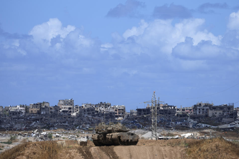 An Israeli tank overlooks the Gaza Strip, as seen from southern Israel, Monday, May 6, 2024. (AP Photo/Tsafrir Abayov)