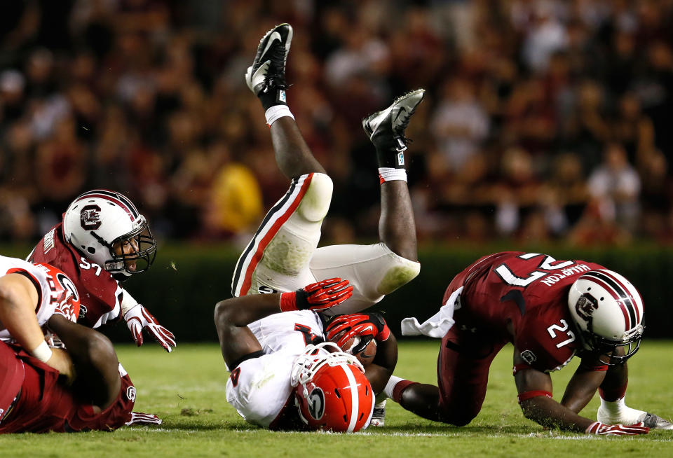 Keith Marshall #4 of the Georgia Bulldogs is tackled by J.T. Surratt #97 and Victor Hampton #27 of the South Carolina Gamecocks at Williams-Brice Stadium on October 6, 2012 in Columbia, South Carolina. (Photo by Kevin C. Cox/Getty Images)