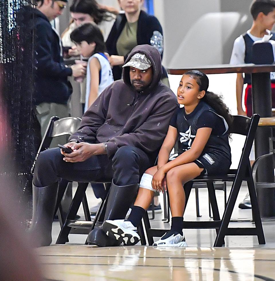 Kanye West with Daughter North West at a basketball game