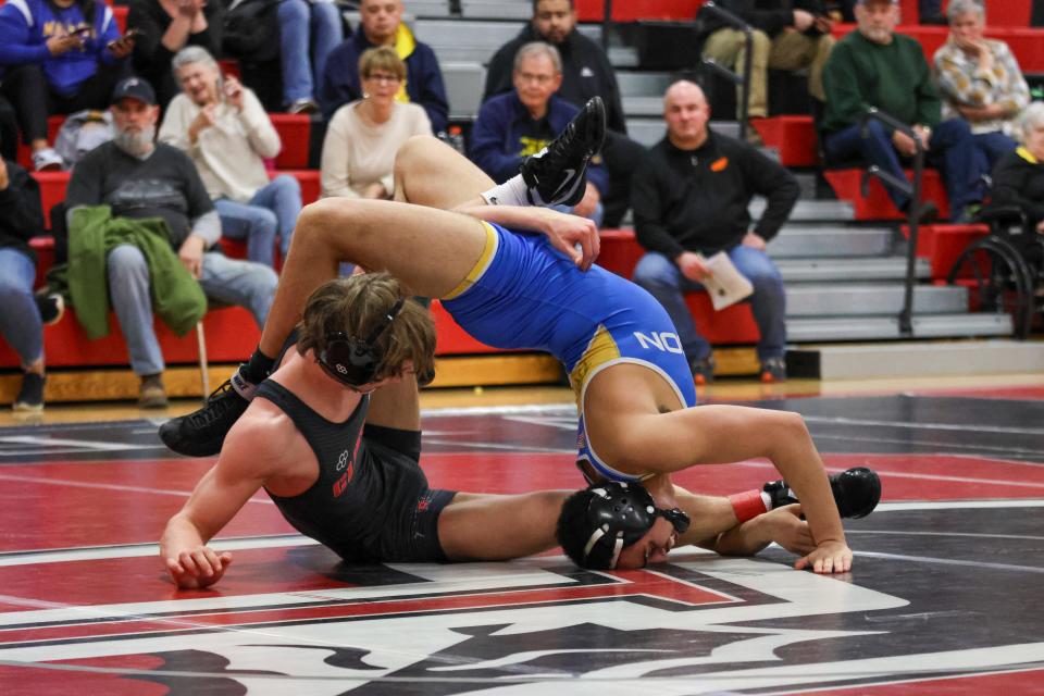 Clinton's Dylan Badge wrestles Xavier Rodriguez in the 144 match during Wednesday's Division 3 district final at Clinton.
