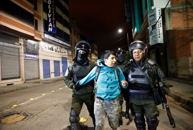 Police detain a supporter of Bolivia's President Evo Morales during clashes in El Alto