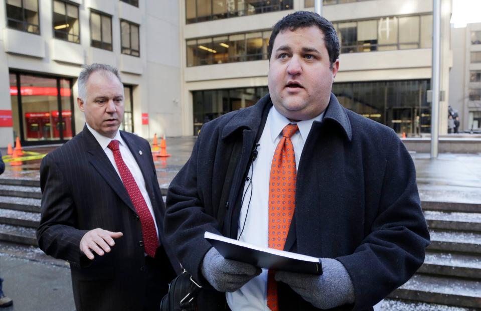 Mason Tvert, right, spokesman for the Marijuana Policy Project, prepares to deliver a petition to National Football League headquarters, Wednesday, Jan. 29, 2014, in New York. He was asking the NFL to allow its players to use marijuana in states where it is legal to do so.