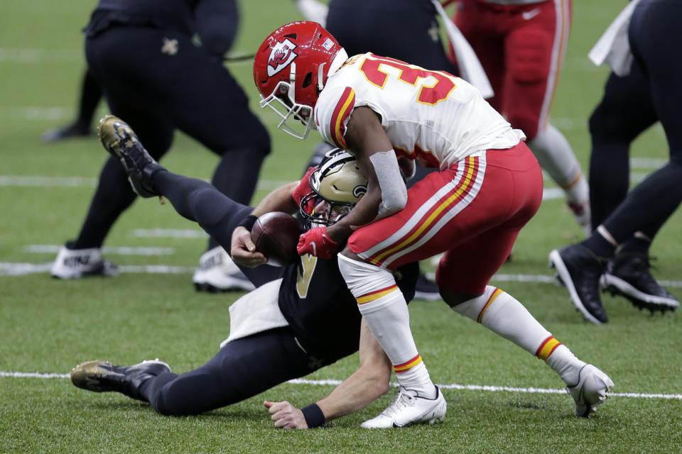 Kansas City Chiefs cornerback L'Jarius Sneed brings down New Orleans Saints quarterback Drew Brees in the first half of an NFL football game in New Orleans, Sunday, Dec. 20, 2020. (AP Photo/Brett Duke)