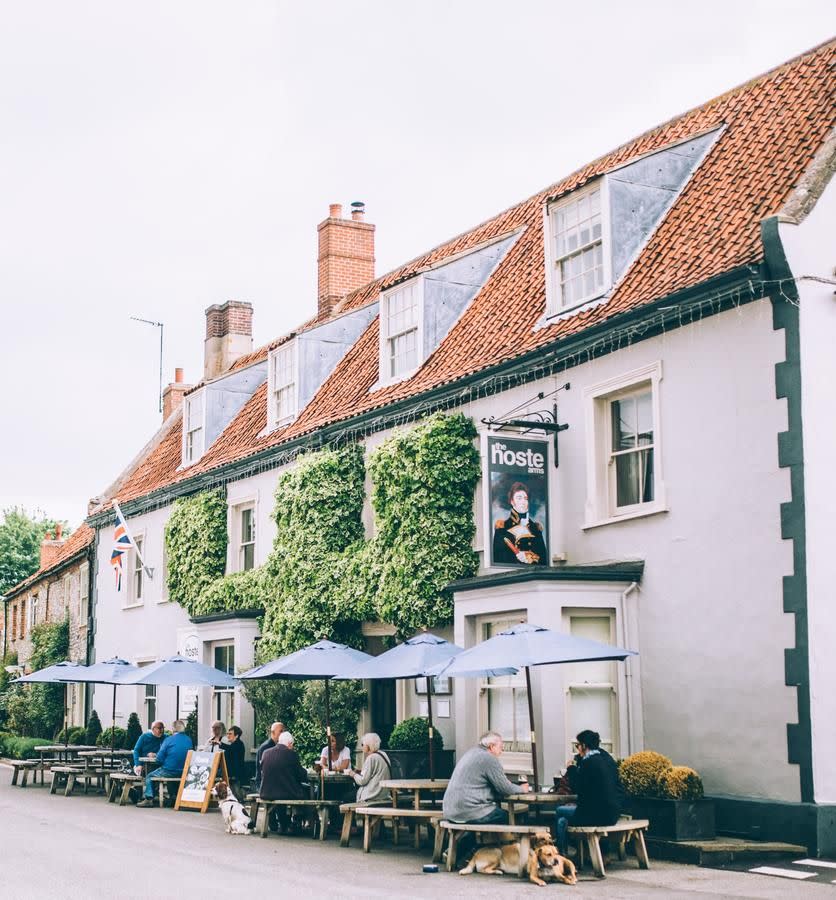 <p>History meets hearty but high-on-taste food at this inn dating back to 1651. Nestled in the picturesque village of Burnham Market on the North Norfolk coastline, it's a beautiful restaurant with rooms with access to sandy strolls and seaside views.</p><p>Its rooms are done up in bold country decor and you can choose from the original building, the new extension, or even a converted train carriage just 800 yards away. </p><p>The locally sourced seasonal produce is served in three different rooms, depending on what takes your fancy; dine by candlelight in the beautiful 17th Century wood-panelled restaurant, feast on hearty bar snacks in the cosy beamed pub, or enjoy an elegant afternoon tea in one of the snug lounges. </p><p><a href="https://www.goodhousekeepingholidays.com/offers/norfolk-kings-lynn-burnham-market-hoste-arms-hotel" rel="nofollow noopener" target="_blank" data-ylk="slk:Read our review of The Hoste Arms.;elm:context_link;itc:0;sec:content-canvas" class="link ">Read our review of The Hoste Arms.</a></p><p><a class="link " href="https://go.redirectingat.com?id=127X1599956&url=https%3A%2F%2Fwww.booking.com%2Fhotel%2Fgb%2Fthe-hoste-luxury-boutique-hotel.en-gb.html%3Faid%3D1922306%26label%3Drestaurants-with-rooms&sref=https%3A%2F%2Fwww.redonline.co.uk%2Ftravel%2Finspiration%2Fg35725040%2Frestaurants-with-room1%2F" rel="nofollow noopener" target="_blank" data-ylk="slk:CHECK AVAILABILITY;elm:context_link;itc:0;sec:content-canvas">CHECK AVAILABILITY</a></p>