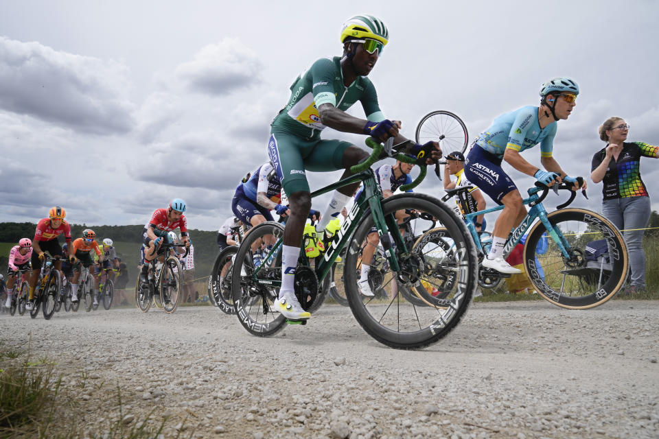 The pack with Eritrea's Biniam Girmay, wearing the best sprinter's green jersey, rides on a gravel road during the ninth stage of the Tour de France cycling race over 199 kilometers (123.7 miles) with start and finish in Troyes, France, Sunday, July 7, 2024. (AP Photo/Jerome Delay)