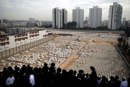 Ultra-Orthodox Jews try to watch the burial of prominent spiritual leader Rabbi Aharon Yehuda Leib Steinman, who died on Tuesday at the age of 104, during his funeral ceremony in Bnei Brak near Tel Aviv, Israel December 12, 2017. REUTERS/Amir Cohen