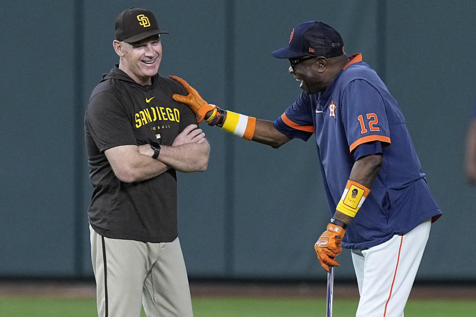 FILE - San Diego Padres third base coach Matt Williams, left, talks with Houston Astros manager Dusty Baker Jr. before a baseball game, Saturday, Sept. 9, 2023, in Houston. In an announcement, Friday, Nov. 10, the San Francisco Giants named Williams as their third base coach on new manager Bob Melvin's staff. (AP Photo/Kevin M. Cox, File)