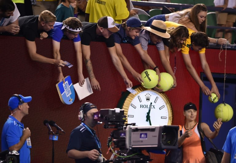 Russia's Maria Sharapova takes a "selfie" for a fan after her second round victory at the Australian Open on January 20, 2016