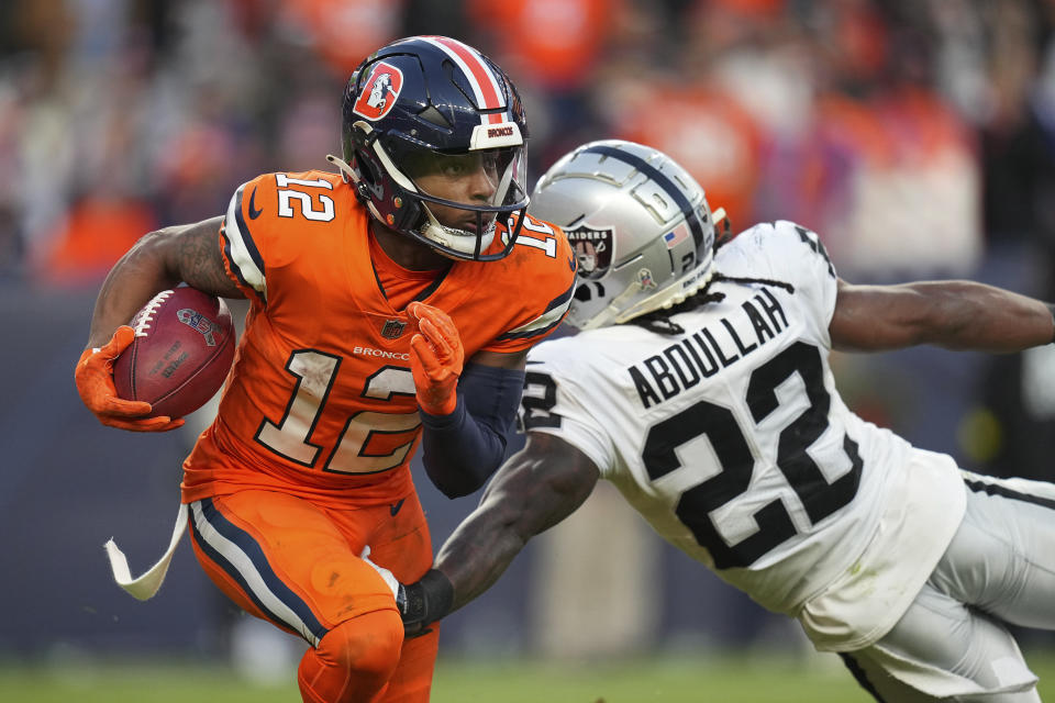 Denver Broncos' Montrell Washington (12) runs against Las Vegas Raiders' Abdullah (22) during the second half of an NFL football game in Denver, Sunday, Nov. 20, 2022. (AP Photo/Jack Dempsey)