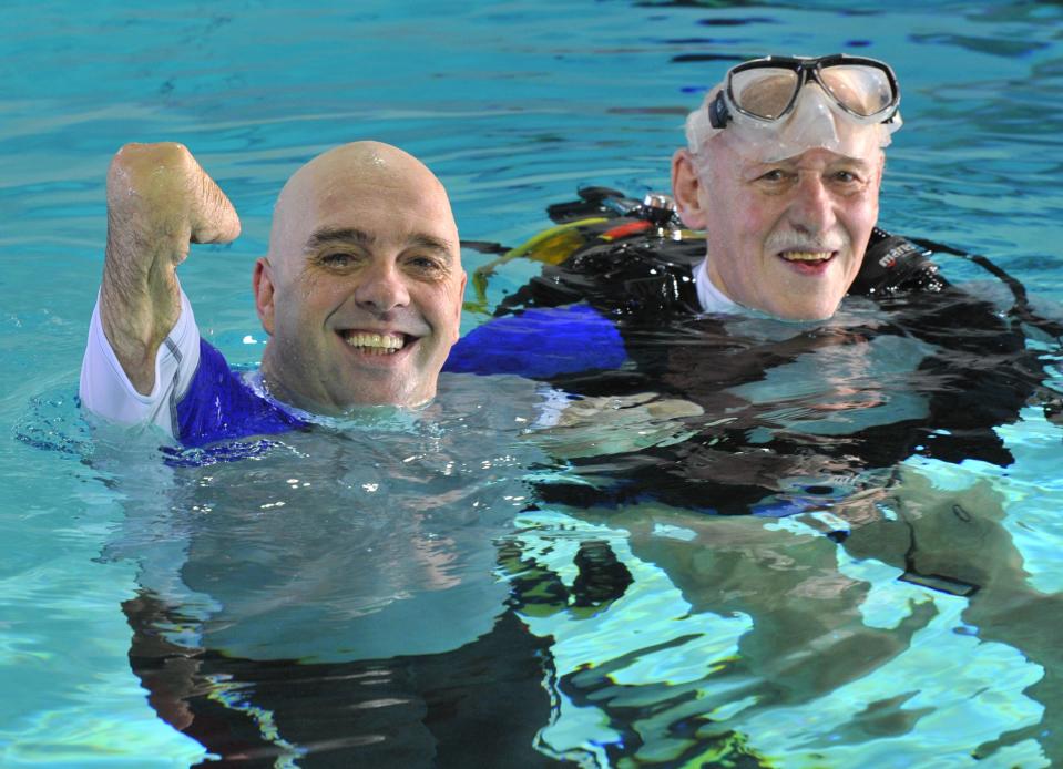 French Philippe Croizon, 44, celebrates on January 10, 2013 after becoming the first quadruple amputee to dive at a depth of 33 meters in the deepest swiming pool in the world in Brussels. He used flippers attached to prosthetic limbs to dive to the bottom of the pool with a group of 15 Belgian divers to set a new world record for an amputee. Croizon had all four limbs amputated in 1994 after being struck by an electric shock of more than 20,000 volts as he tried to remove a TV antenna from a roof. He has swum across the English Channel and all five intercontinental channels. AFP PHOTO GEORGES GOBETGEORGES GOBET/AFP/Getty Images