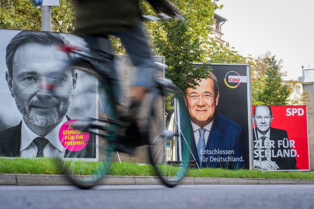 21 September 2021, Berlin: A cyclist rides past large election posters with the chancellor candidates of the SPD with Olaf Scholz (r-l), of the CDU with Armin Laschet and the FDP top candidate Christian Lindner. On 26.09.2021 the German citizens are called to elect a new Bundestag. Photo: Kay Nietfeld/dpa (Photo by Kay Nietfeld/picture alliance via Getty Images) (Photo: picture alliance via Getty Images)