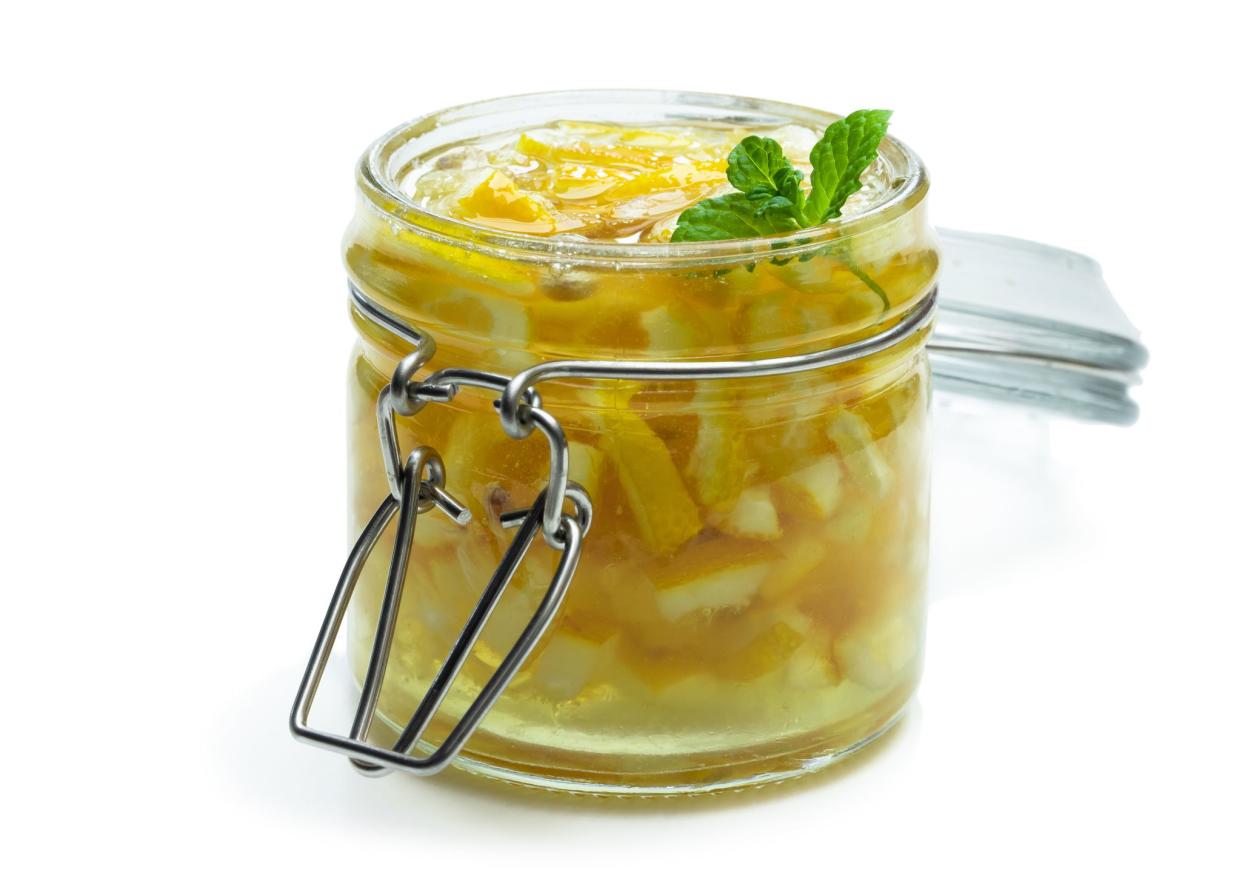 Lemon  jam in glass jar isolated on white