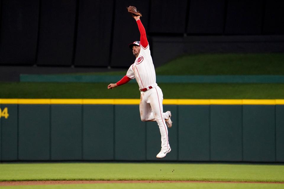 Cincinnati Reds shortstop Matt Reynolds (4) leaps to catch a line drive during the seventh inning of a baseball game against the New York Mets, Monday, July 4, 2022, at Great American Ball Park in Cincinnati.
