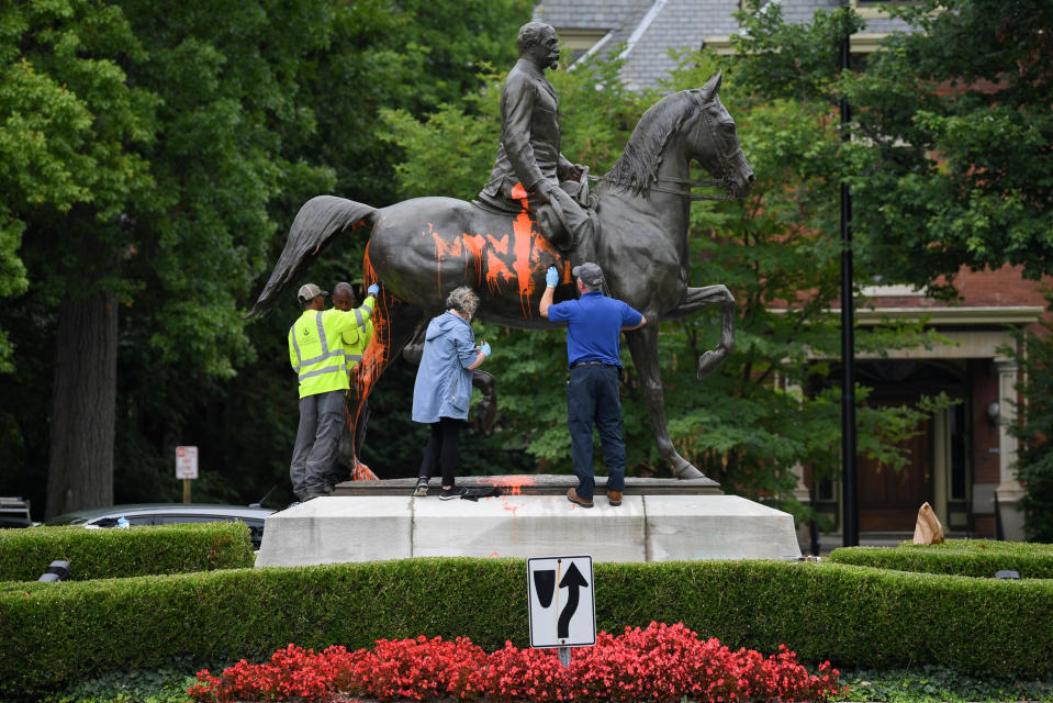 <p>Municipal workers attempt to remove paint from a monument dedicated to Confederate soldier John B. Castleman that was vandalized late Saturday night in Louisville, Ky., Aug.14, 2017. (Photo: Bryan Woolston/Reuters) </p>