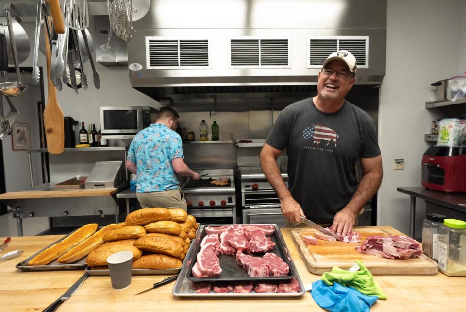 John Madden's grandson Jack Madden (left) helps cook and friend Doug Duke prepare their NFL Sunday feast.