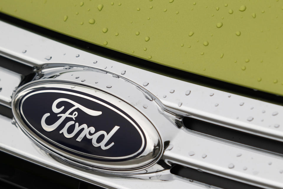 FILE - In an Aug. 31, 2011 file photo raindrops are on the grill of a 2012 Ford Fiesta SE at the Maroone Ford of Miami dealership. Ford Motor Co. said Wednesay July 25, 2012, its net income fell by 57 percent to $1 billion in the second quarter as losses in Europe and Asia mounted. (AP Photo/Wilfredo Lee/file)