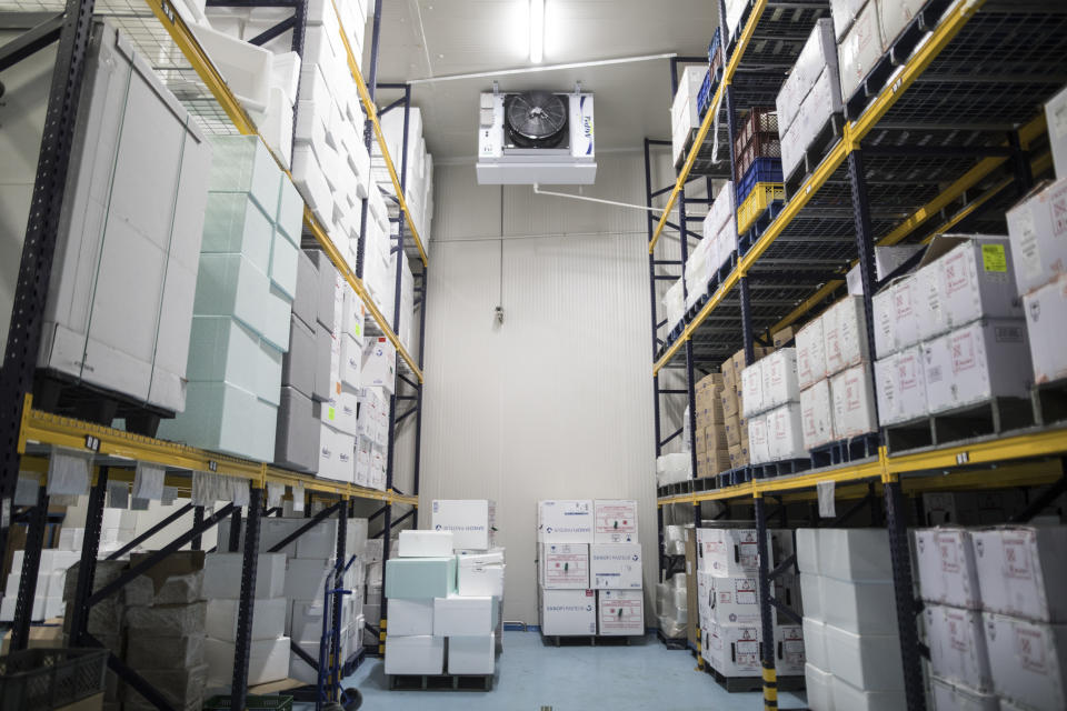 Boxes of vaccines, unrelated to COVID-19, are stored in a large refrigerator, during a media tour of the ministry warehouse where the vaccine for the new coronavirus will also be stored in freezers in Bogota, Colombia, Tuesday, Jan. 19, 2021. (AP Photo/Ivan Valencia)