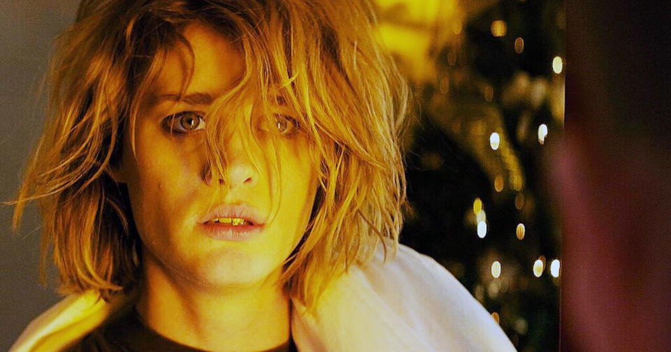 Mackenzie Davis's character wearing a blood-splattered white jacket