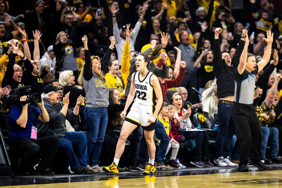 Iowa's Caitlin Clark celebrates after breaking the NCAA women's college basketball all-time scoring record on Thursday in Iowa City.