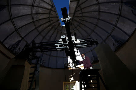 Devendran, a 55-year-old observer, positions the six-inch telescope at the Kodaikanal Solar Observatory, India, February 6, 2017. REUTERS/Danish Siddiqui