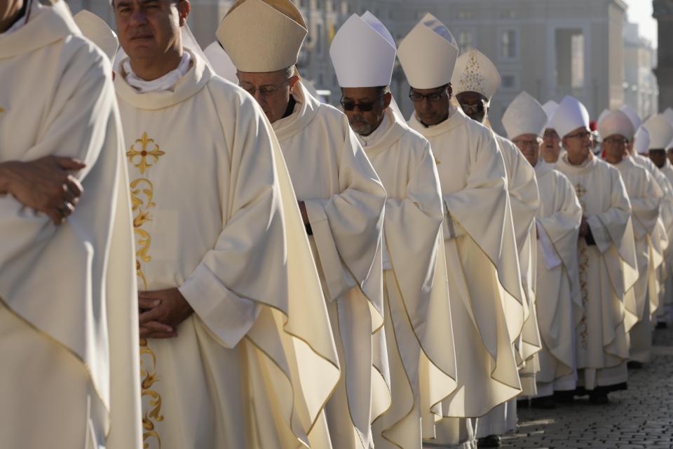 Prelates arrive for a mass presided over by Pope Francis and concelebrated by the new cardinals for the start of the XVI General Assembly of the Synod of Bishops in St. Peter's Square at The Vatican, Wednesday, Oct.4, 2023. Pope Francis is convening a global gathering of bishops and laypeople to discuss the future of the Catholic Church, including some hot-button issues that have previously been considered off the table for discussion. Key agenda items include women's role in the church, welcoming LGBTQ+ Catholics, and how bishops exercise authority. For the first time, women and laypeople can vote on specific proposals alongside bishops (AP Photo/Andrew Medichini)