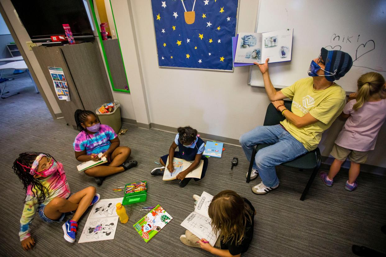 Mikel Waymouth reads to children Aug. 18, 2021, at the Boys & Girls Clubs main campus in South Bend.