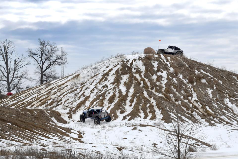 Off-road enthusiasts try their luck at scaling a mini-mountain at Holly Oaks ORV Park.